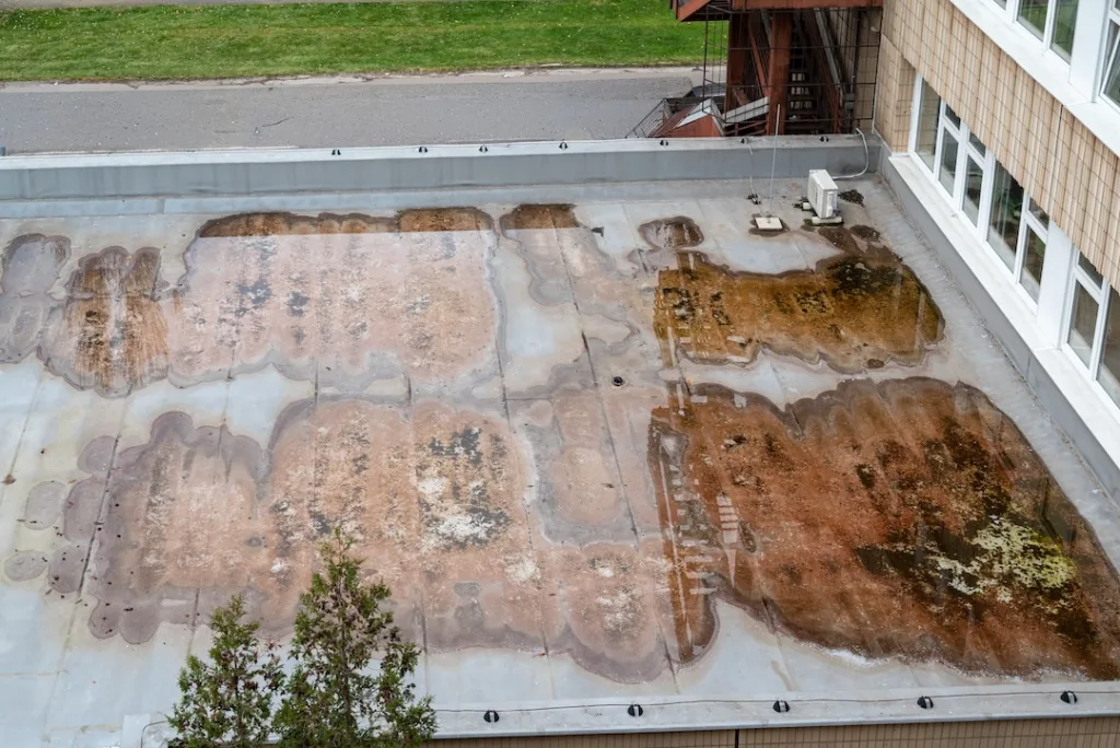 Standing Water Pooling on Flat Roof Showing Poor Drainage System Clean Aerial View