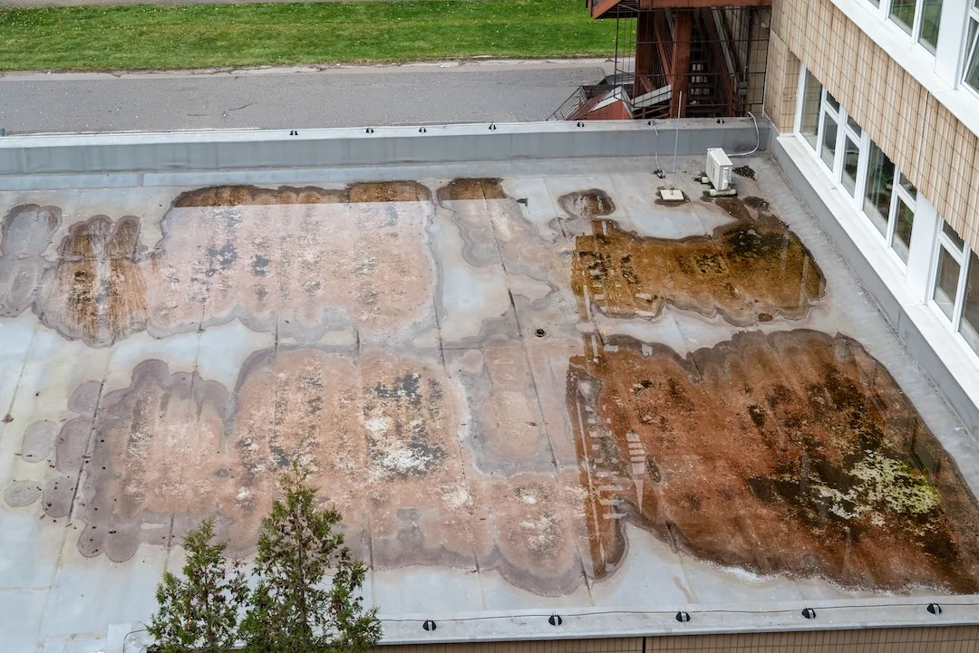 Standing Water Pooling on Flat Roof Showing Poor Drainage System Clean Aerial View